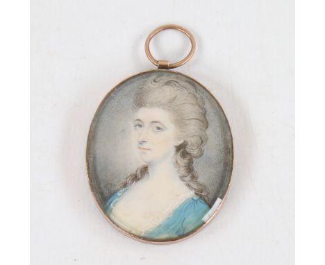 A Georgian miniature painted portrait on ivory, depicting a woman wearing a blue dress, unsigned, in unmarked gold pendant fr