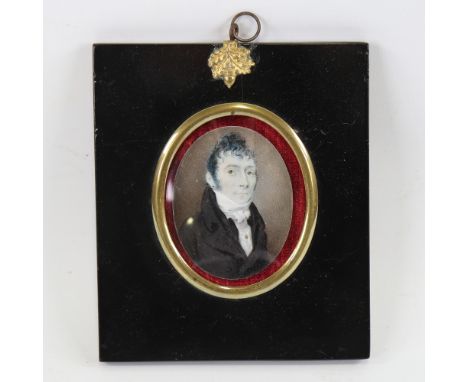 A Regency miniature painting on ivory, portrait of a gentleman wearing a black coat with stock, unsigned, in brass-mounted eb