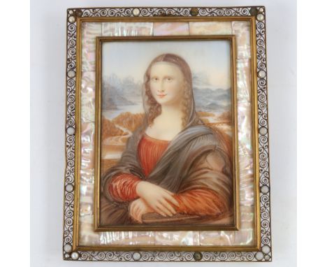 An early 20th century painted portrait on ivorine after Leonardo, The Mona Lisa, in ornate brass filigree frame with mother-o