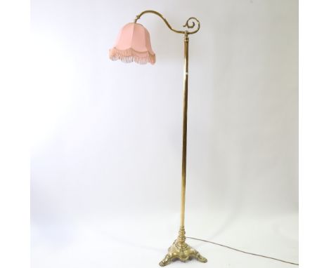 A late 19th early 20th century brass standard lamp with pink shade, height 168cm