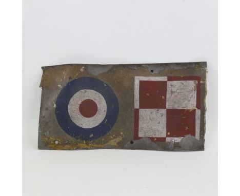 A Vintage metal panel from a British Military aircraft, with painted insignia, 30cm x 15.5cmBent with several holes and gener