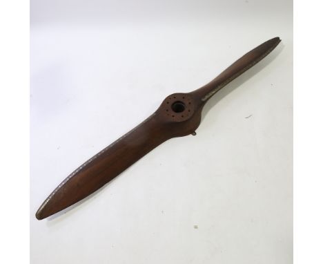 A Vintage laminate wood aircraft propeller, with riveted metal edge, length 190cm (6'3")1 tip is slightly chipped 