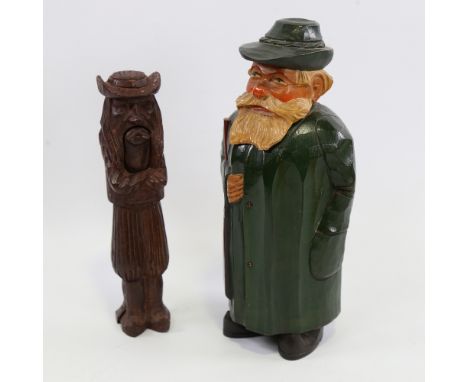 A 19th century Black Forest carved wood figural nutcracker, length 21cm, and a carved and painted wood decanter in the form o
