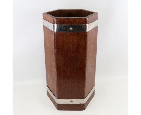 A 1930s oak stick stand of hexagonal form, by Lister & Co, with chrome plate bands, height 50cmMetal liner in the base, chrom