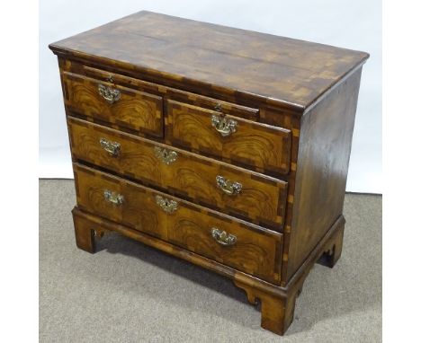 An 18th century figured walnut bachelor's chest of drawers, with brushing slide, ornate multi-panel veneer top and bracket fe