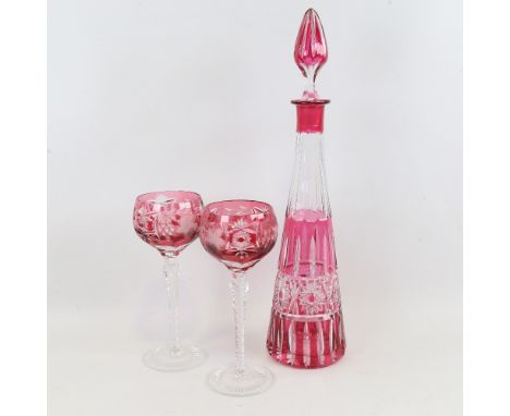A French&nbsp;cranberry overlay cut-glass decanter, height 42cm, and a pair of similar hock glasses Good condition, no chips 