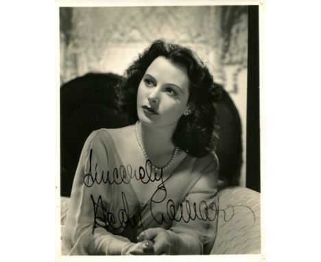 LAMARR HEDY: (1913-2000) Austrian-born American Actress. A good vintage signed 8 x 10 photograph of the actress seated in a h