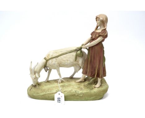 A Royal Dux Pottery Model of a Girl Holding a Goat on a Lead, upon a naturalistic oval rocky base, shape number 1493, pink tr