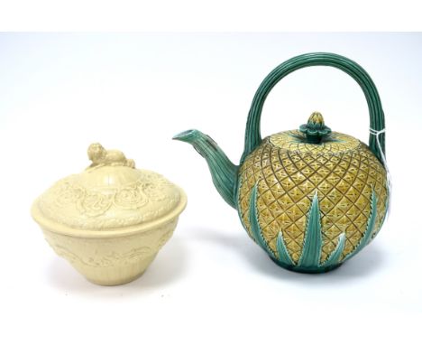 A Mid XIX Century Pottery Majolica Teapot and Cover, modelled in the form of a pineapple, with green loop handle and fluted s