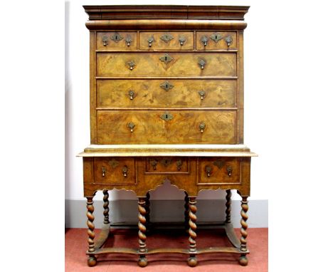 A William and Mary Walnut Chest-on-Stand, the top with stepped pediment, cushion drawer over three short and three long drawe