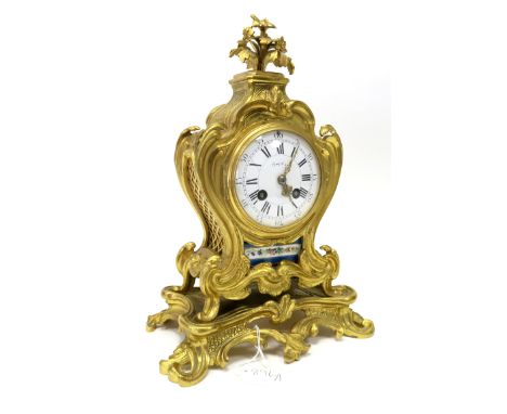 A Late XIX Century French Ormolu Clock, of rococco form with flower surmount, floral painted panels, upon a footed pierced ba