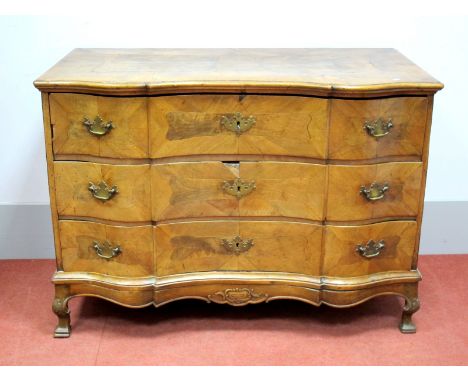 An XVIII Century Walnut Serpentine Shaped Commode, the top with two panels, moulded edge, three graduated drawers and shaped 