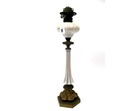 A Late XIX Century Oil Lamp, the white opaque fluted column with foliate scrolling decorated reservoir, ormolu mounts and hex