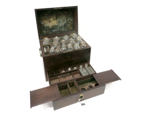 An Early XIX Century Mahogany Apothecary Chest, with brass carrying handles, the lid opening to reveal fourteen glass bottles