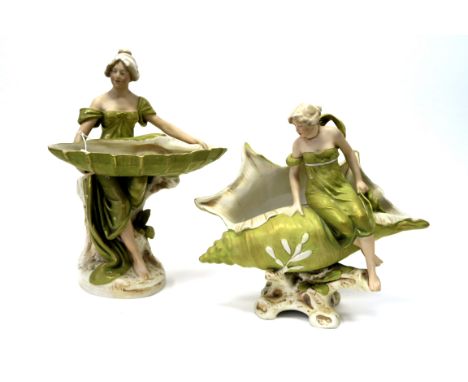 A Royal Dux Pottery Model of a Lady Seated on a Rock Holding a Large Shell, upon a naturalistic oval rocky base, shape number