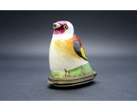 An Early XIX Century South Staffordshire Enamel Bonboniére, modelled in the form of a bird on a grassy mound, hinged cover, 4