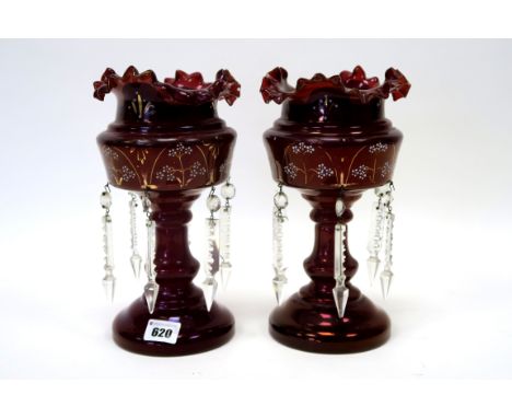 A Pair of Late XIX Century Ruby Glass Table Lustres, decorated in gilt and white enamel with flowers, hung with prismatic dro