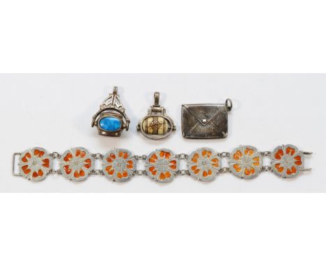 A 925 silver gemset spinning fob, an unmarked silver spinning fob, a silver stamp holder pendant, and a silver with enamel fl