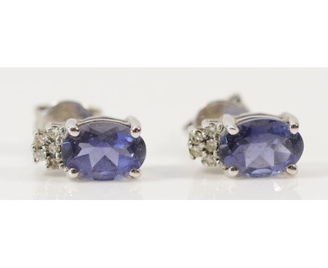 A pair of 9ct white gold amethyst and diamond earrings with scroll backs, 1.5g