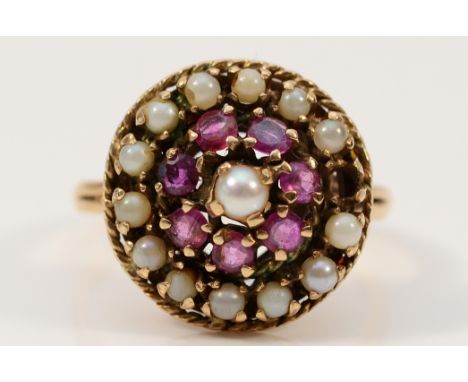 A 9ct gold ruby and seed pearl cluster ring, one setting vacant, P, 4.5g