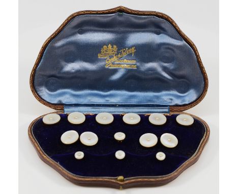 An Edwardian 9ct rose gold, mother of pearl and half pearl dress set, comprising six buttons, a pair of cufflinks and a set o