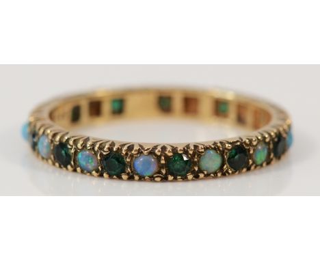 A 9ct gold emerald and opal full eternity ring, U, 2.8g Condition-Stamped 9ct, no missing stones, no chips or cracks, in need