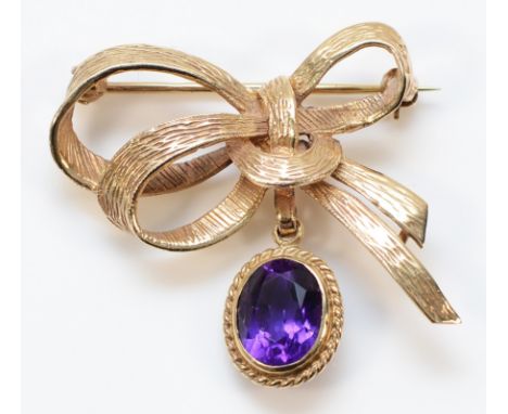 A 9ct gold amethyst bow shaped brooch, 35mm across, 6.8g