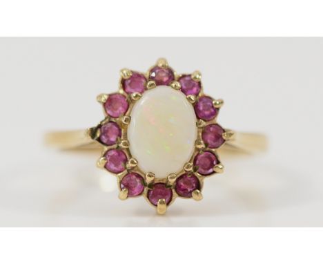 A 9ct gold ruby and opal cluster ring, Birmingham 1990, O, 2.8g Condition-Full UK hallmarks, there is damage to one claw hold
