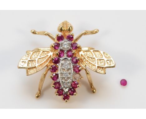 A 14K gold diamond and ruby fly brooch, one ruby setting is vacant but the ruby is present, 22mm, 3.2g