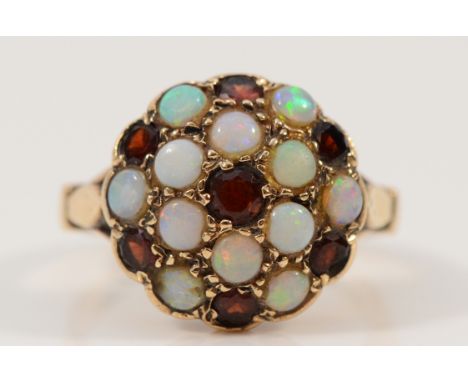 A 9ct gold garnet and opal cluster ring, one opal is chipped, O 1/2, 5g