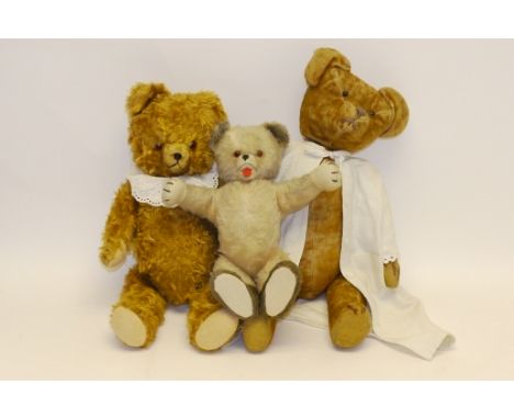 Three Continental Teddy Bears, A French example with short dark orange mohair, boot button eyes, stitched nose and mouth, swi