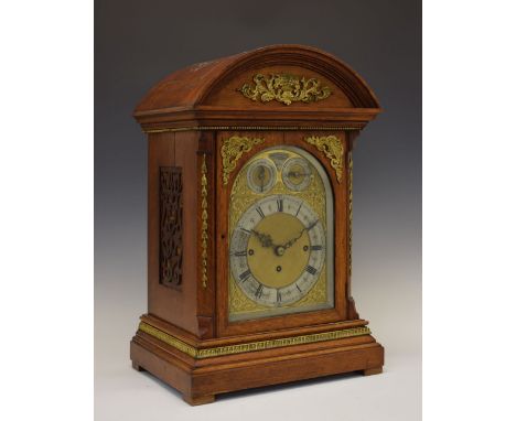 Edwardian oak-cased triple-fusee bracket or table clock, retailed by Benetfink &amp; Co, London, having an arched 7.5-inch br