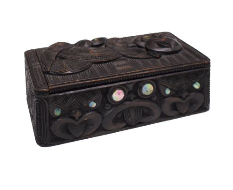 New Zealand Interest - 20th Century shell-inlaid carved stain wooden 'treasure box', the cover carved with a Tiki with mother
