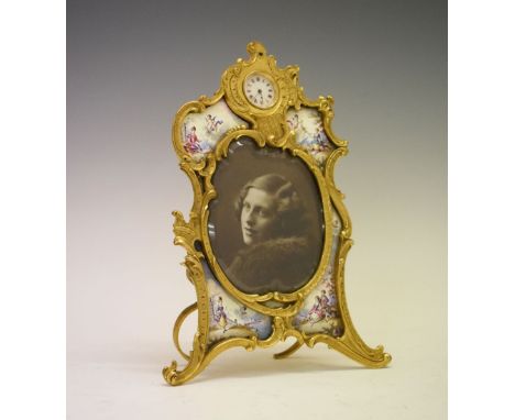 Early 20th Century Continental gilt metal and enamel photograph frame with timepiece having horse and rider motif at VI, surm