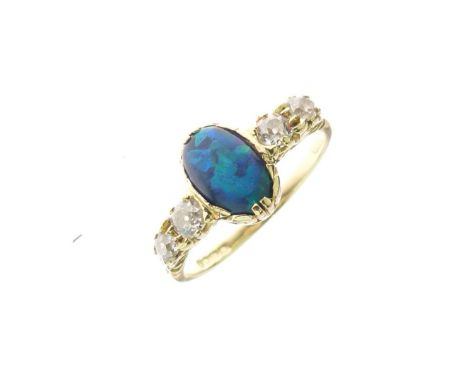 18ct gold, diamond and opal dress ring, the central cabochon (a black opal or doublet) approx 8mm x 6mm, flanked by two pairs