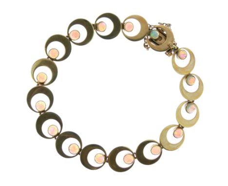 Yellow metal flexible bracelet, of repeating crescent design set with sixteen opal circular cabochons, clasp stamped 15, 15.9