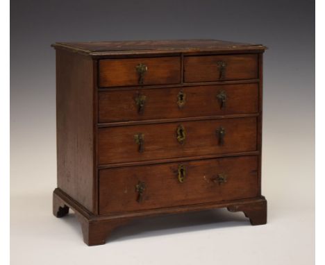 George III 'apprentice piece' miniature chest of drawers, in walnut and mahogany, the walnut-cross banded moulded top over tw