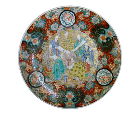 Early 20th Century Japanese porcelain charger, late Meiji/Taisho, depicting the Eight Immortals with scrolls on a gilt-enrich