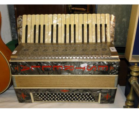 An Estrella piano accordion, with case