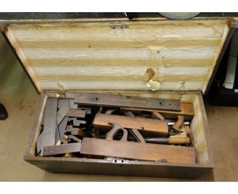 A painted pine box containing carpenter's woodworking tools.
