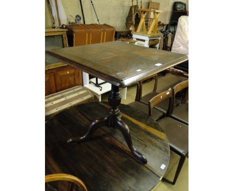 An oak snap top tripod table