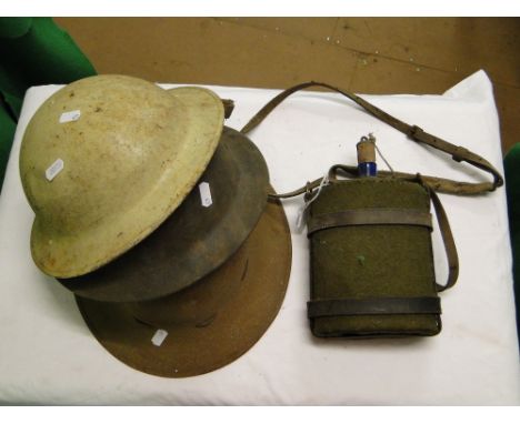 3 Army helmets and a flask.
