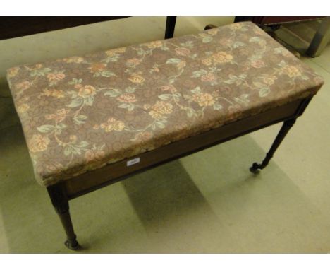 An Edwardian mahogany and satinwood banded duet piano stool on turned legs.