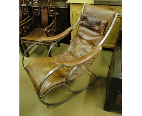 A late 19th century/20th century iron and leather rocking chair by R W Winfield.