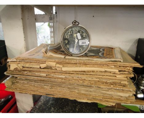 Antique newspapers & an alarm clock