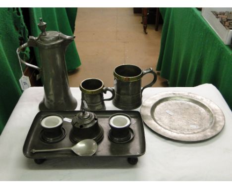 A pewter desk stand, spoon, 19th century pewter mugs with brass rims, engraved coffee pot, etc.