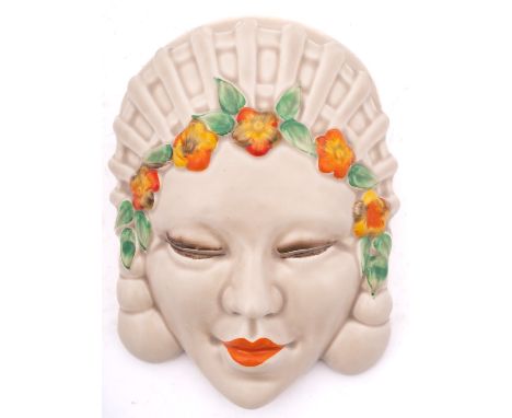 A Clarice Cliff 'Marlene' mask wall pocket  wearing an elaborate headdress and floral band to her forehead, printed Clarice C