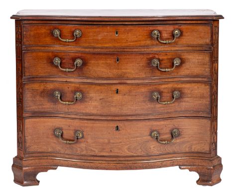 A George III mahogany chest of serpentine outline in the Chippendale manner, the top with a moulded edge and projecting cante