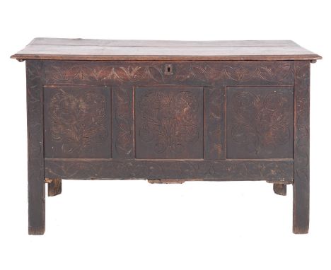 A West Country oak coffer, possibly Devonshire, late 17th century; the hinged cover with moulded edges; the three panel front