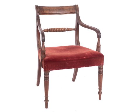 A Regency mahogany elbow chair, the back with reeded curved bar top rail and turned and spirally reeded horizontal splat, hav